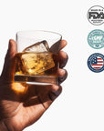 Hand holding a glass of Driftology Chamomile Nightcap with ice, featuring FDA and GMP logos on a white background