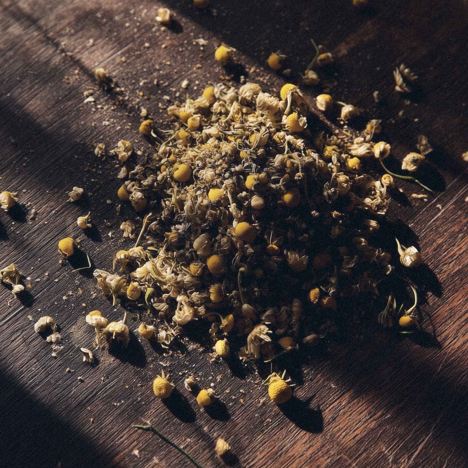 Dried chamomile flowers on a wooden surface