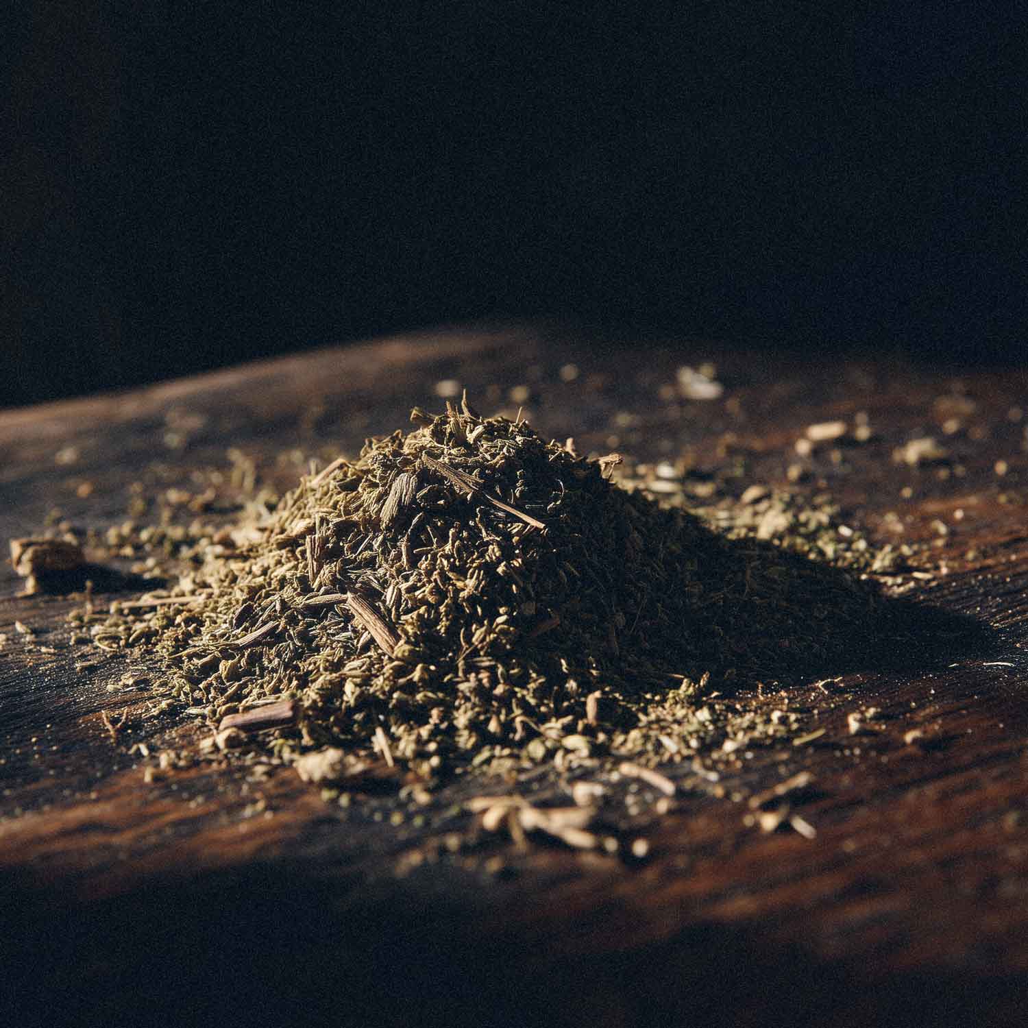 Dry valerian root on a wooden surface with a dark background